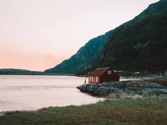 Een huisje aan een meer in Bodø, Noorwegen. Een toffe locatie voor een coolcation in Scandinavië.